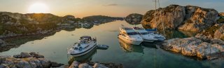 Boats and sailboat moored up in the sunset in Norway